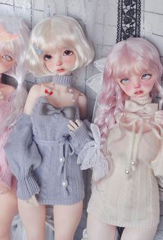 three dolls are standing next to each other