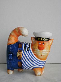 a cat figurine wearing a sailor's outfit