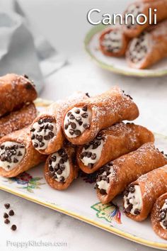 chocolate covered crepes on a plate with the words cannoli above them