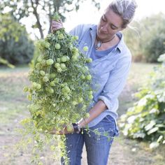 a woman is holding grapes in her hands