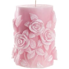 a pink candle that has some flowers on it