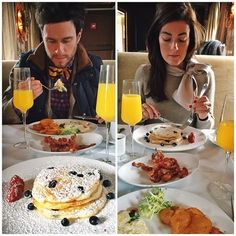 a man and woman sitting at a table eating breakfast