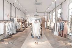 an empty clothing store with clothes on racks