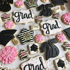 decorated graduation cookies are displayed on a table