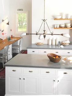 the kitchen is clean and ready to be used for cooking or baking, while also being used as a dining area