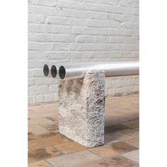 a concrete bench with three pipes attached to it