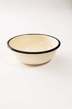 a white and black bowl sitting on top of a table