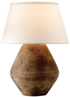 a table lamp with a white shade on it's base and a brown vase