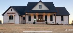 a white house with black roof and windows