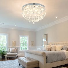 a bedroom with a large bed and chandelier