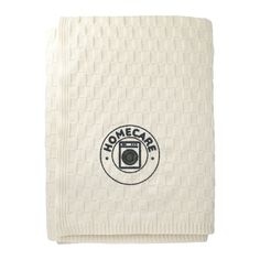 a white towel with the words home care on it and a camera in the center