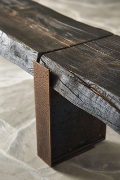 a wooden bench sitting on top of a stone floor