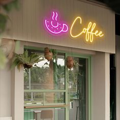 a coffee shop with a neon sign above the door