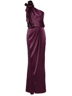 a woman wearing a long purple dress with one shoulder draped over the top and an asymmetrical bow at the back