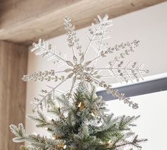 a small christmas tree with snowflakes on it