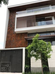 an apartment building with trees in front of it