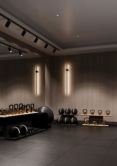 an empty room with many vases and bowls on the table in front of it