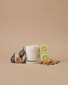 a candle and some figs on a table