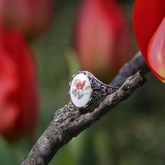 Victorian style German Tulip Cameo.  Available on an antiqued brass or silver vintage ring.I do not recommend that this be worn while bathing or swimming although normal handwashing is fine. Antique Oval Flower Ring Gift, Antique Oval Flower Ring As Gift, Antique Oval Flower Ring As A Gift, Vintage Oval Flower Ring, Vintage Silver Flower Ring Gift, Vintage Silver Flower Ring For Gift, Silver Vintage Flower Ring For Gift, Vintage Cabochon Rings For Gifts, Vintage Cabochon Rings As Gift