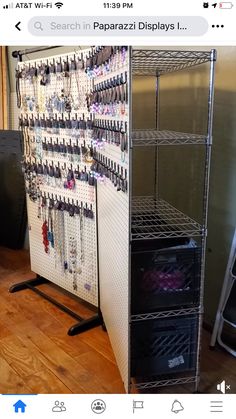 a metal rack filled with jewelry on top of a hard wood floor