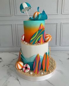 a multi layer cake decorated with candy and beach decorations