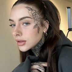 a woman with tattoos on her face and neck