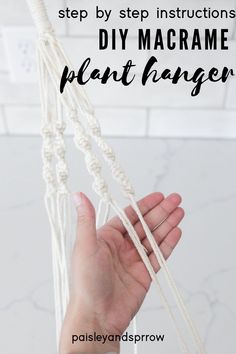 someone is holding up their macrame plant hanger with text overlay that reads, step by step instructions diy macrame plant hanger