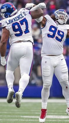 two football players are jumping in the air