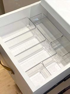 an open drawer with clear drawers on the bottom is shown in this image, it appears to be empty