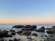 the beach is covered with rocks and water