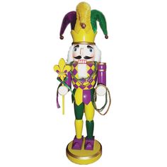 a wooden nutcracker is standing on a stand with a purple and yellow hat