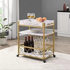 a kitchen cart with wine glasses and plates on it