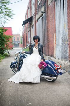 a woman in a wedding dress sitting on a motorcycle