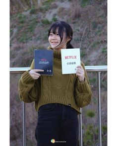 a woman holding up two books in front of her face