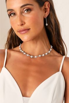 Any occasion that calls for the Lulus Elevated Luxury Silver Rhinestone Pearl Necklace and Earring Set is sure to be a glamorous and memorable event! This stunning jewelry set starts with a dazzling silver necklace that features a series of rhinestone-embellished medallions with shiny faux pearl centers. The matching earrings boast a drop silhouette with slender chains accented with clear rhinestones and the same eye-catching medallions at the ends for a posh finish. Necklace has a lobster clasp closure. Earrings have post backs. Earrings measures 1. 50" long. Necklace measures 12. 5" long with a 6" extender chain. 50% Iron, 35% Stone, 15% Plastic. Imported. Lulus | Elevated Luxury Silver Rhinestone Pearl Necklace and Earring Set. Pearl Necklace And Earring Set, Pearl Necklace And Earrings, Necklace And Earring Set, Silver Rhinestone, Stunning Jewellery, Clear Rhinestones, Matching Earrings, Long Necklace, Jewelry Set