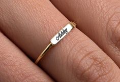 This Simple Name Ring is 14k Solid GOLD ( not filled or plated) You can customize this name ring with the name/word/date/mantra of your choice. Gold Name Ring is the best jewelry you could ever find. This will be the best gift for you and your loved one. All our gold/silver rings are suitable for Nameplate Engraved Ring For Gift, White Engraved Ring For Promise With Name, Customized Gold Engraved Ring As Gift, Customized Gold Engraved Ring For Gift, Custom Gold Engraved Personalized Ring, 14k Gold Engraved Nameplate Ring For Gift, Gold Nameplate Engraved Ring As Gift, White Rings With Custom Name For Gift, Custom Name White Ring As Gift