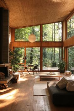 a living room filled with furniture and windows covered in wooden paneled walls next to a fire place