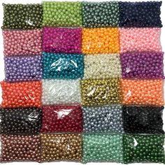 many different colors of beads are arranged in the shape of a square, on top of each