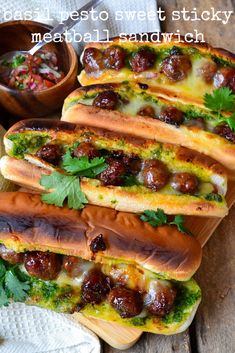 four hot dogs with meatballs and cheese on them