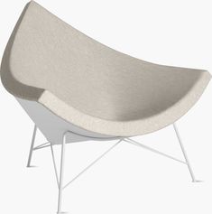 a gray and white chair sitting on top of a metal frame