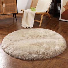 a chair and rug in a room with wooden floors, white fur on the floor