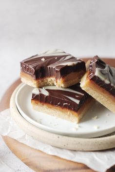 three pieces of chocolate and marshmallow bars on a plate