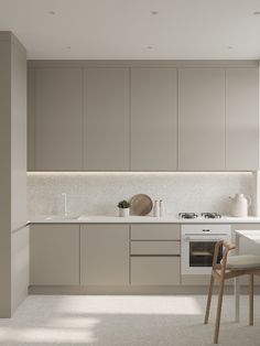 a kitchen with white counter tops and light colored cabinets, along with a dining table