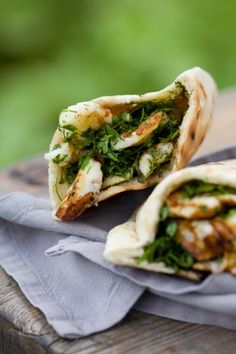 two pita breads sitting on top of a wooden table