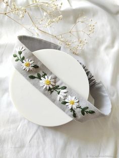 a white plate topped with flowers on top of a table