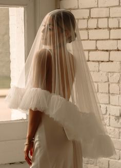 a woman wearing a wedding veil and dress