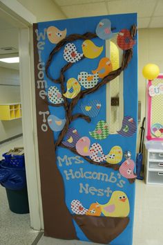 a door decorated to look like a tree with birds on it and the words welcome to mrs holcoom's nest