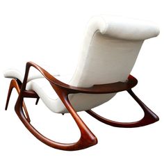 a white leather rocking chair with wooden legs and arms, on an isolated white background