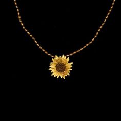 a necklace with a sunflower on it