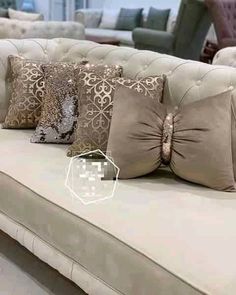 a couch with many pillows on it in a store